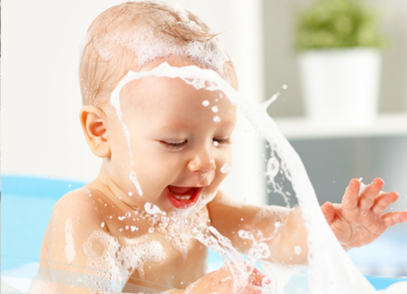 Baby splashing in soap bubbles