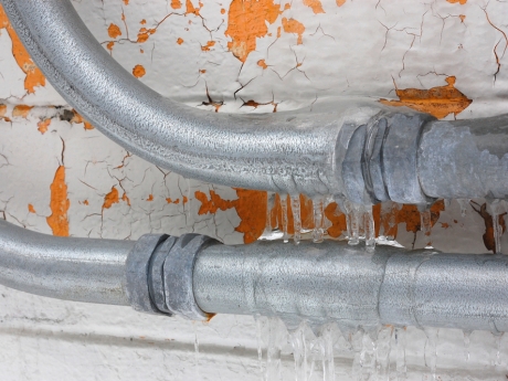 two frozen pipes covered in ice